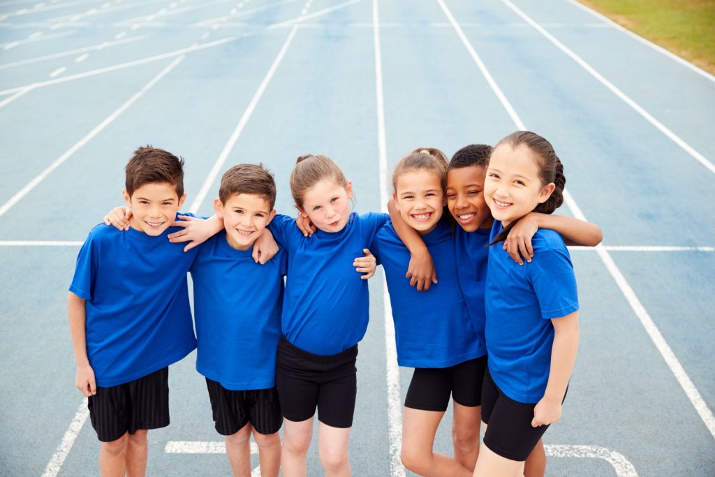 Portrait Of Children In Athletics Team On Track On Sports Day