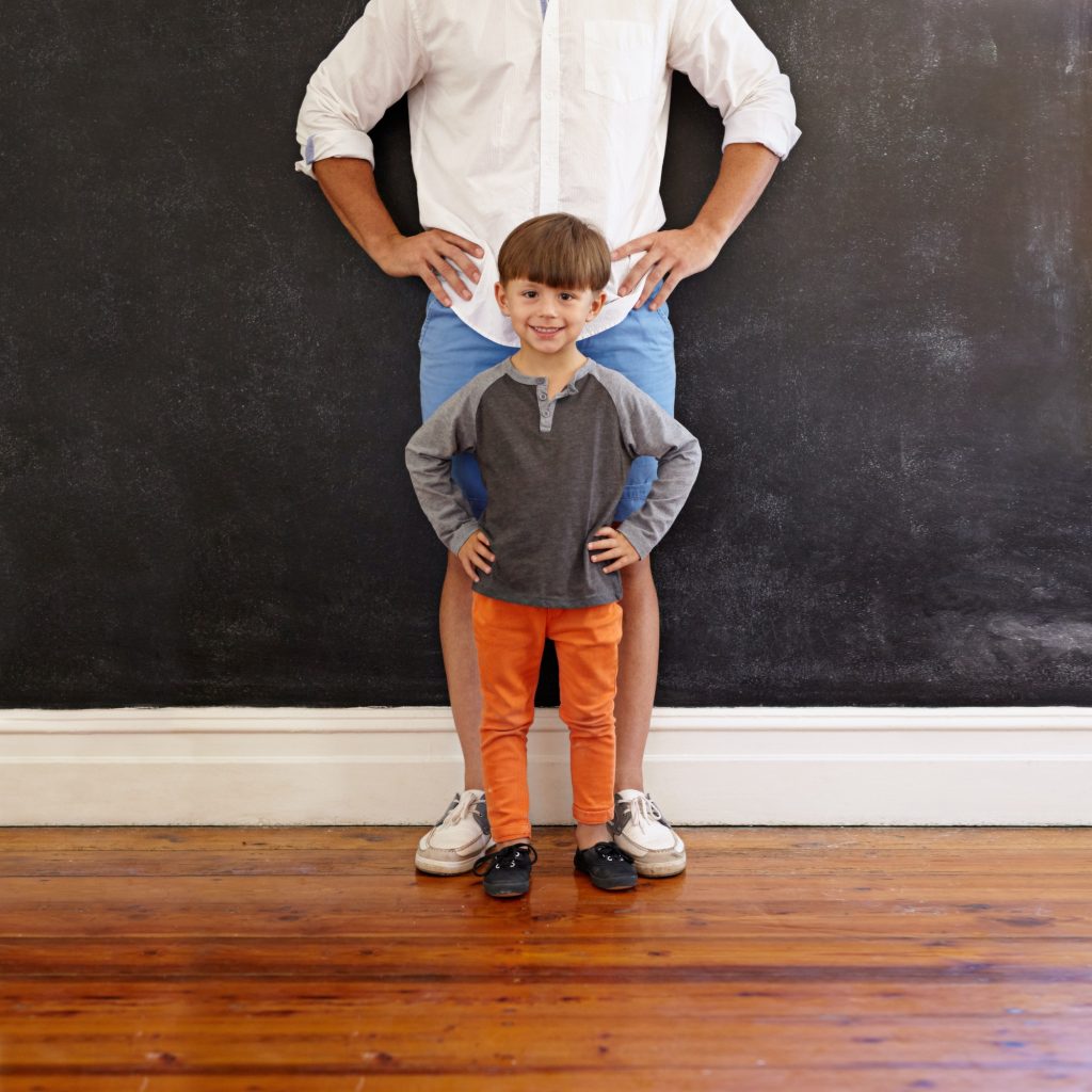 Father and son hands on waist