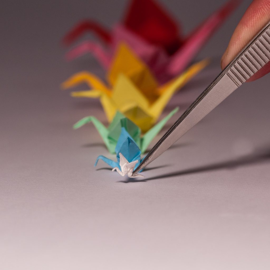 Miniature origami cranes in multiple colours